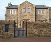 Dry-stone walls and pillars to a house in Upper Cumberworth.