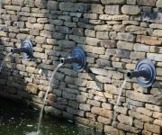 Here we have built dry-stone walls as feature elements to a swimming pool and pond in a garden at Richmond London.