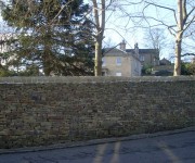 Dry-stone walls and pillars to a house in the village of Honley.